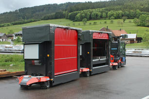 Outdoor AGV: Factory Train autonomous outdoor tugger train with materials handling load carrier